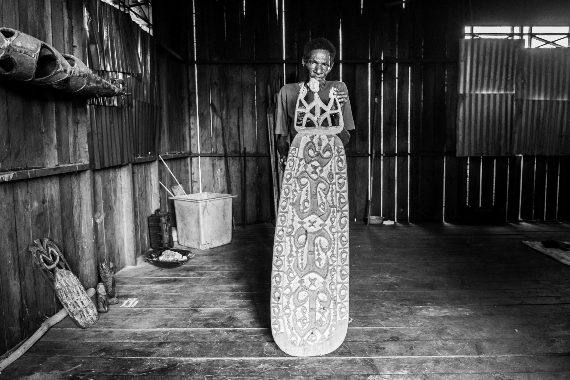 Simon with a special shield decorated with sacred symbols that will be offered to the ancestors.
