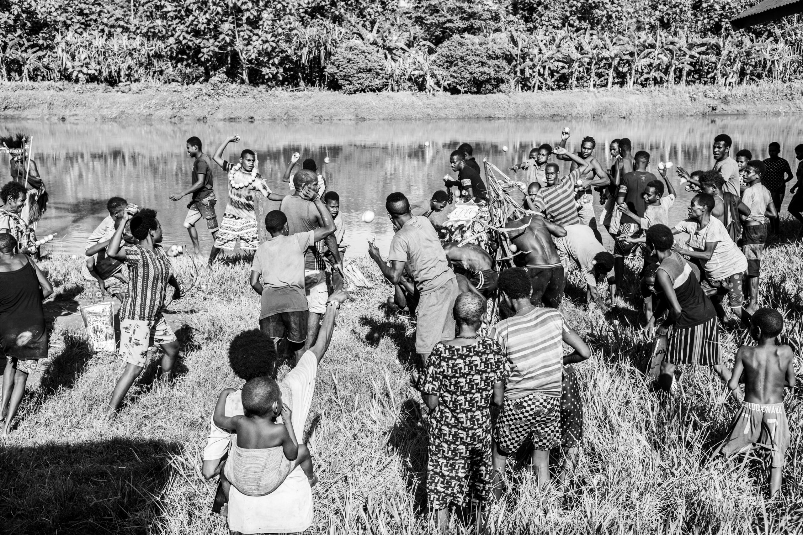 They throw fruits at evil spirits so that evil spirits do not bring bad things into the midst of life in the village.